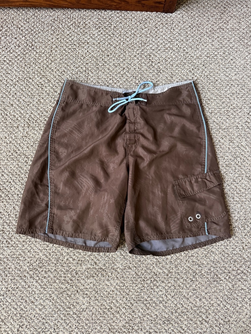 brown and blue y2k grunge style swim trunks with skull pattern